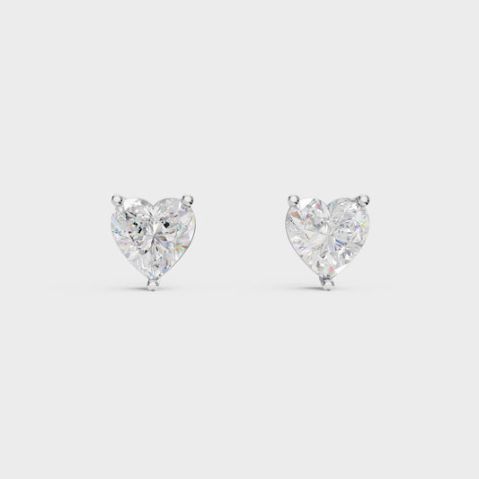 Heart-shaped diamond earrings on a light gray background
