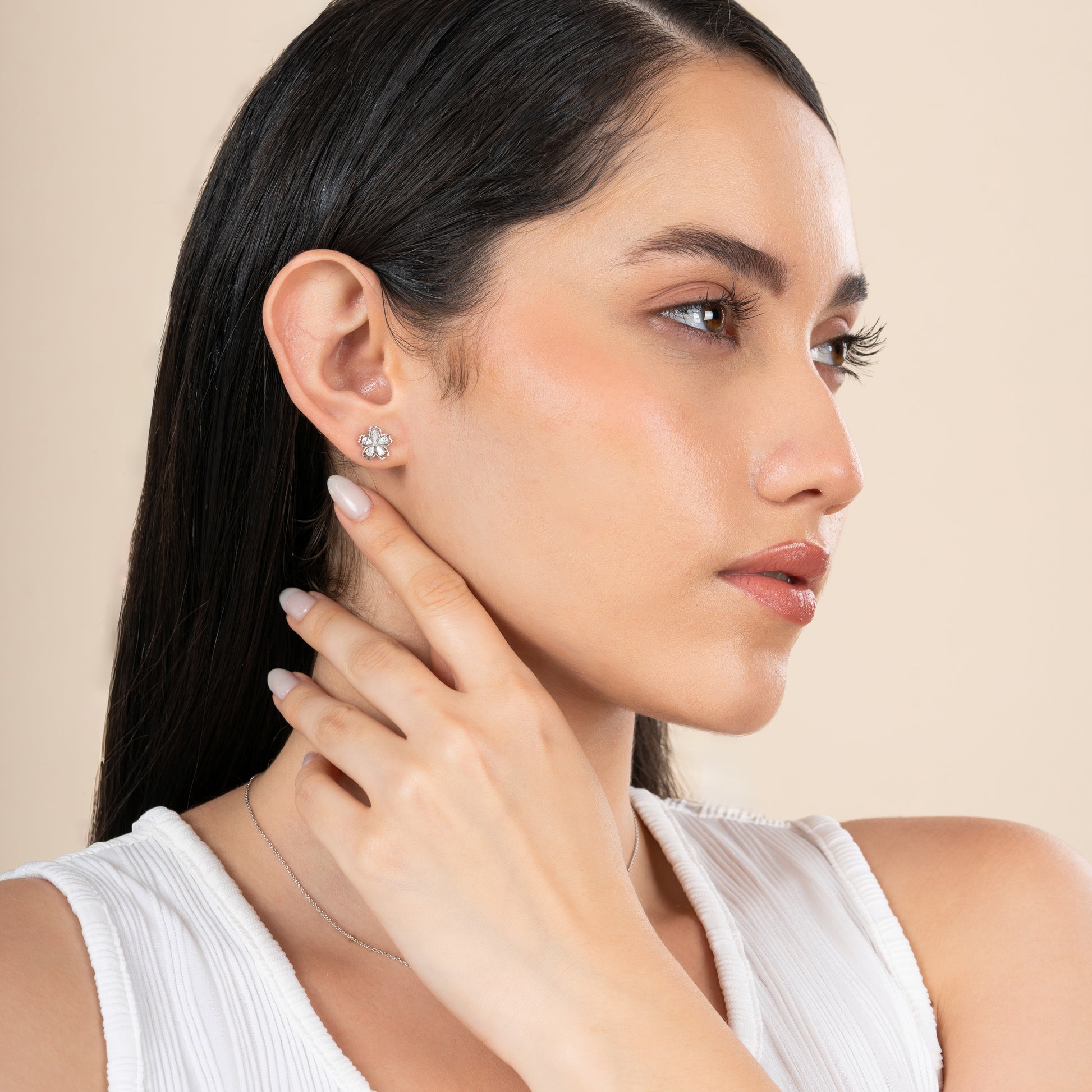 This image features a close-up view of a woman showcasing a elegant flower-shaped earring from the Flower Shape Jewelry Set. The earring is designed with a central, possibly gemstone, surrounded by a delicate pattern of petals that enhance its visual appeal.